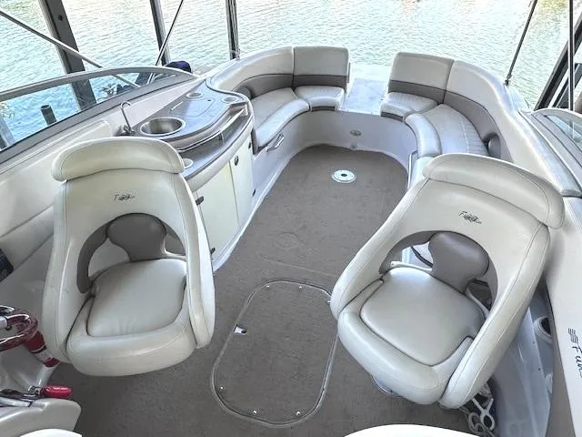 Slide: The Image of Interior of 2003 Four Winns 264 Funship boat with plush seating and a compact sink area. - 7