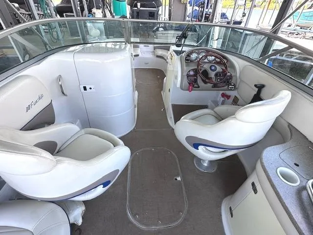 Slide: The Image of 2003 Four Winns 264 Funship boat interior with white seating and control panel. - 8