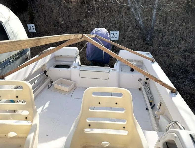 Slide: The Image of 2011 Grady-White 208 Adventure boat interior with seating and covered engine. - 10