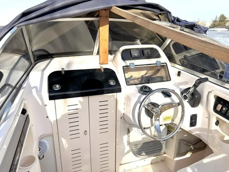 Slide: The Image of 2011 Grady-White 208 Adventure boat cockpit with steering wheel and control panel. - 11