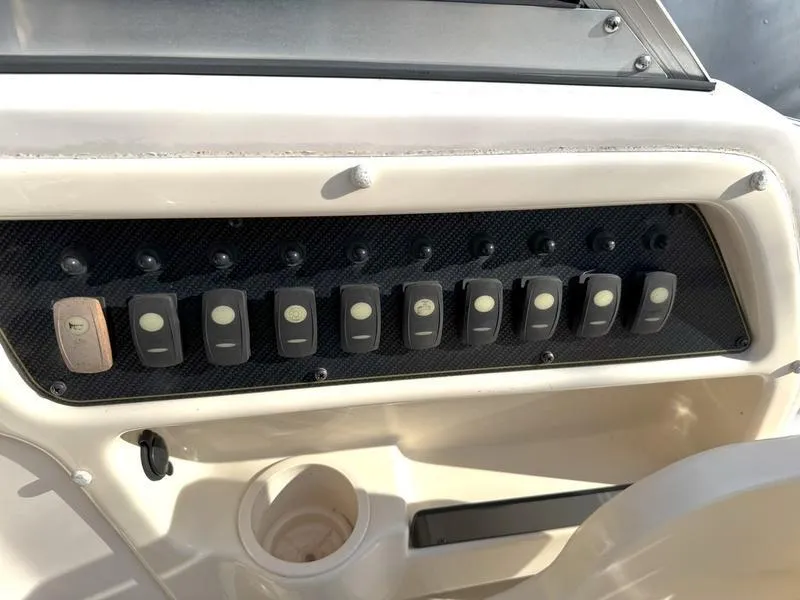 Slide: The Image of Control panel of 2011 Grady-White 208 Adventure boat with multiple switches. - 12