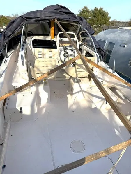 Slide: The Image of 2011 Grady-White 208 Adventure boat interior with protective cover and wooden support beams. - 13