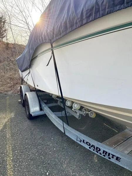 Slide: The Image of 2011 Grady-White 208 Adventure boat on Load Rite trailer, covered and parked outdoors. - 15