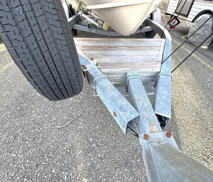 Slide: The Image of Trailer for 2011 Grady-White 208 Adventure boat with visible tire and metal frame. - 16