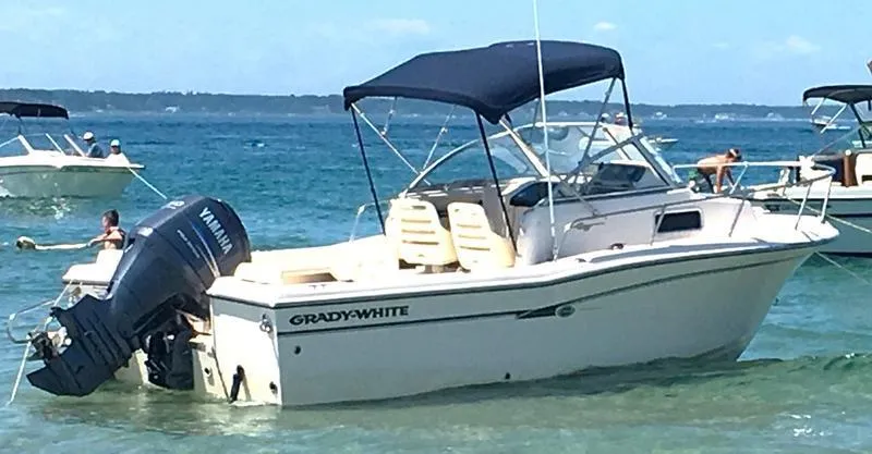 Slide: The Image of 2011 Grady-White 208 Adventure boat with Yamaha outboard, anchored in clear blue water. - 18