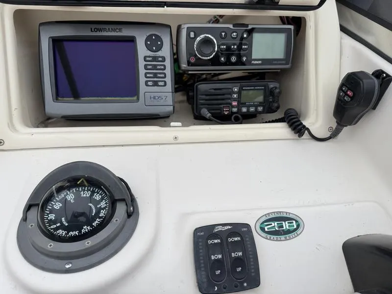 Slide: The Image of Dashboard of a 2011 Grady-White 208 Adventure boat with navigation and communication equipment. - 19