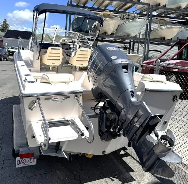 Slide: The Image of 2011 Grady-White 208 Adventure boat with Yamaha outboard motor, docked in a marina. - 22