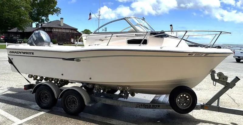 Slide: The Image of 2011 Grady-White 208 Adventure boat on trailer in parking lot, sunny day. - 27