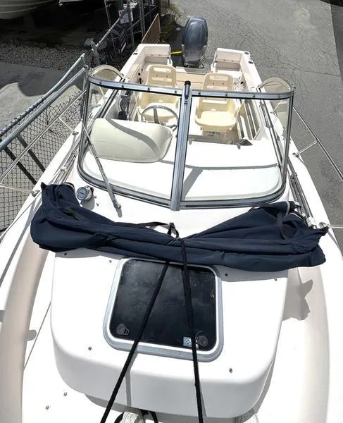 Slide: The Image of 2011 Grady-White 208 Adventure boat with windshield and seating, docked outdoors. - 29