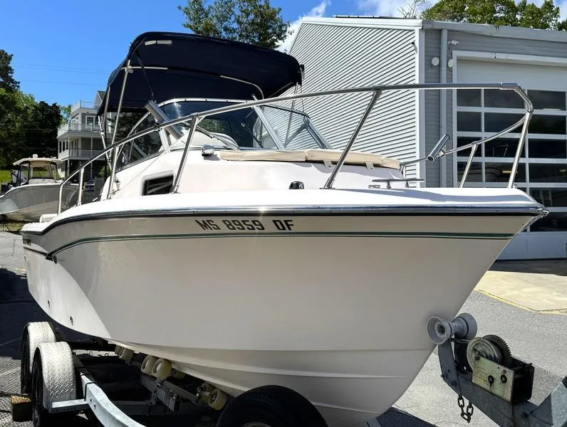 Slide: The Image of 2011 Grady-White 208 Adventure boat on trailer, parked outdoors. - 30