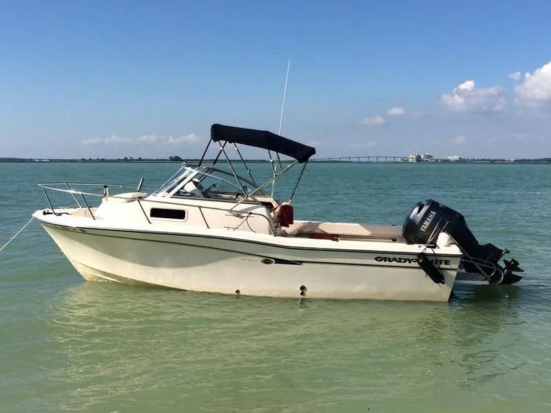 Slide: The Image of 2011 Grady-White 208 Adventure boat on calm water, clear sky background. - 7