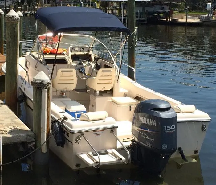 Slide: The Image of 2011 Grady-White 208 Adventure boat docked, featuring Yamaha 150 outboard motor. - 9
