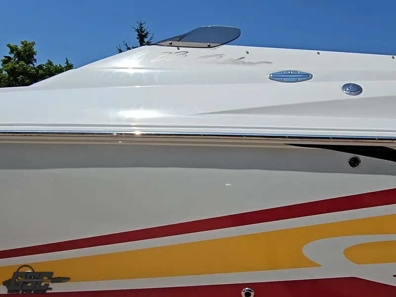 Slide: The Image of 2005 Baja 33 Outlaw boat with sleek design and vibrant red-yellow accents. - 24