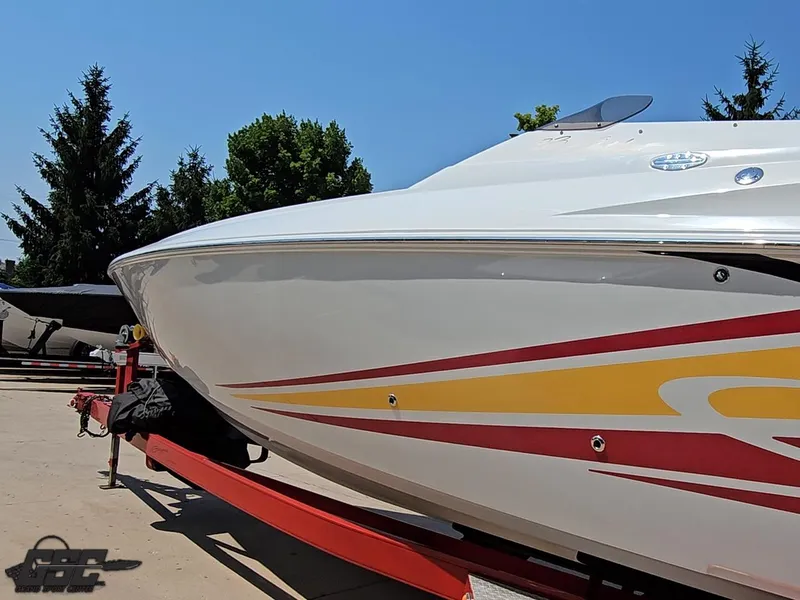 Slide: The Image of 2005 Baja 33 Outlaw boat on trailer, featuring sleek design and vibrant graphics. - 25