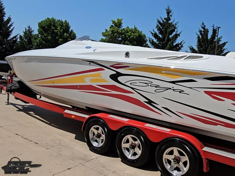 Slide: The Image of 2005 Baja 33 Outlaw speedboat on a red trailer, featuring vibrant graphics. - 27