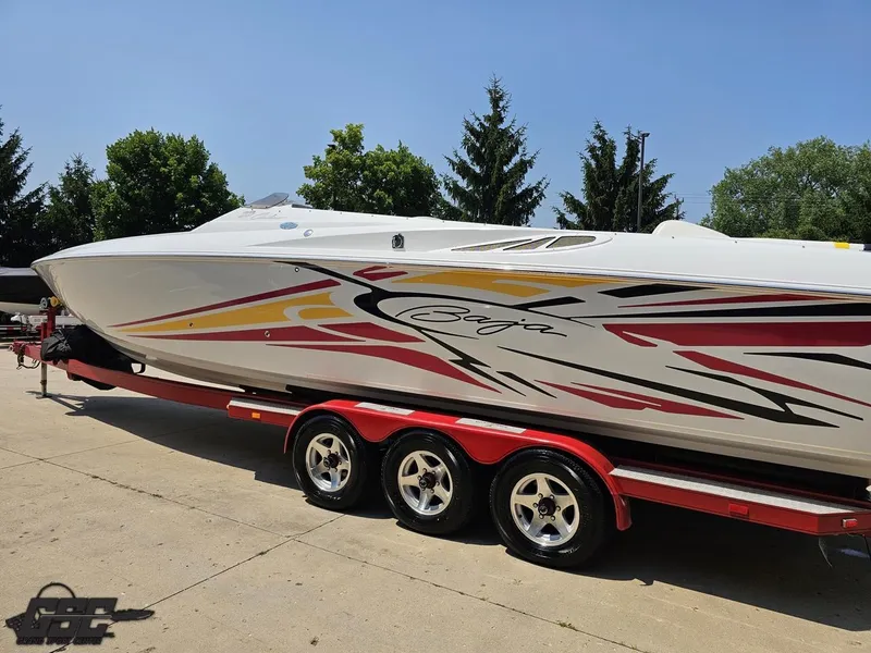 Slide: The Image of 2005 Baja 33 Outlaw speedboat on trailer, featuring vibrant graphics and sleek design. - 28