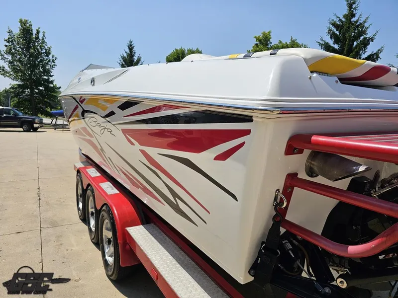 Slide: The Image of 2005 Baja 33 Outlaw boat with vibrant graphics on a red trailer. - 30
