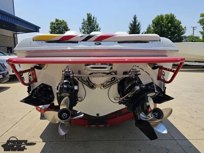 Slide: The Image of Rear view of a 2005 Baja 33 Outlaw boat with dual propellers and vibrant design. - 32