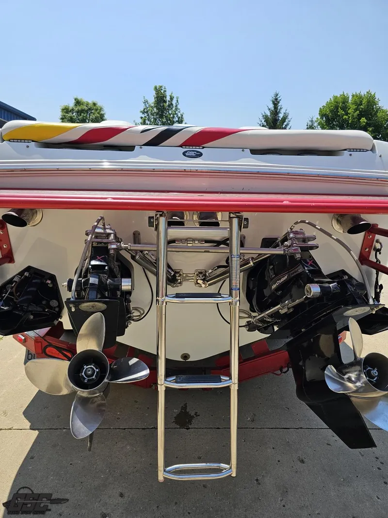 Slide: The Image of 2005 Baja 33 Outlaw boat stern with dual propellers and ladder in sunlight. - 37