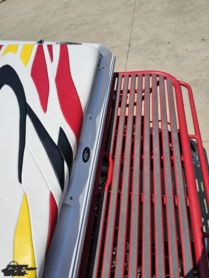 Slide: The Image of 2005 Baja 33 Outlaw boat with colorful upholstery and red metal railing. - 38
