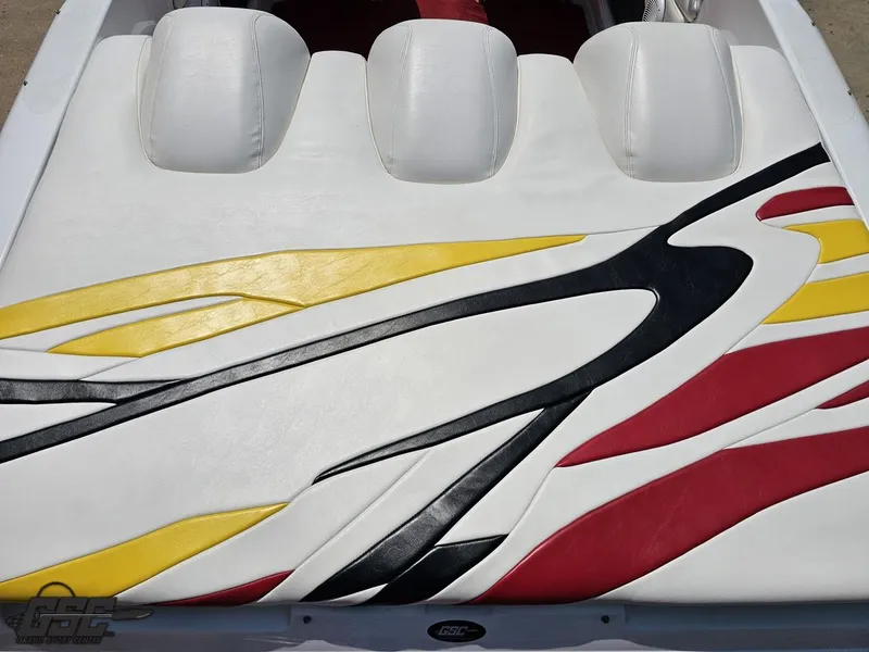 Slide: The Image of 2005 Baja 33 Outlaw boat interior with colorful, abstract upholstery design in white, yellow, and red. - 43