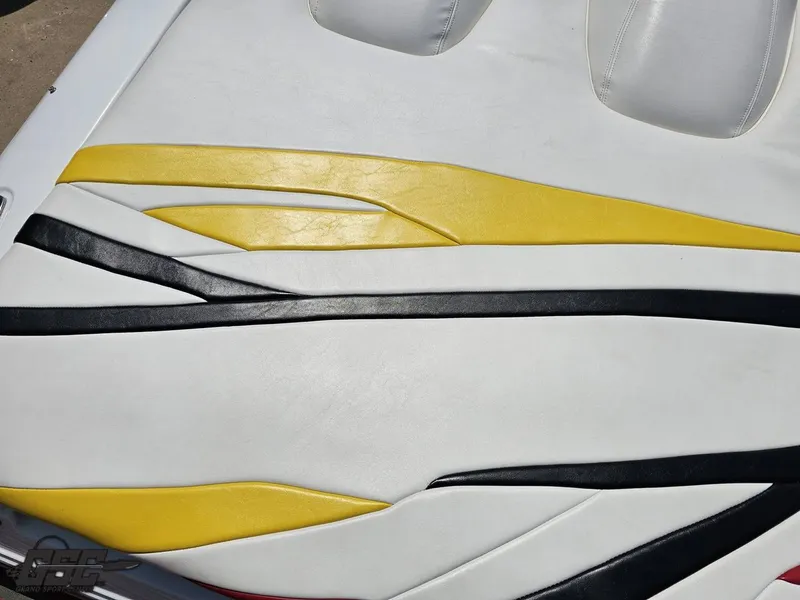 Slide: The Image of White, yellow, and black upholstery on a 2005 Baja 33 Outlaw boat seat. - 44