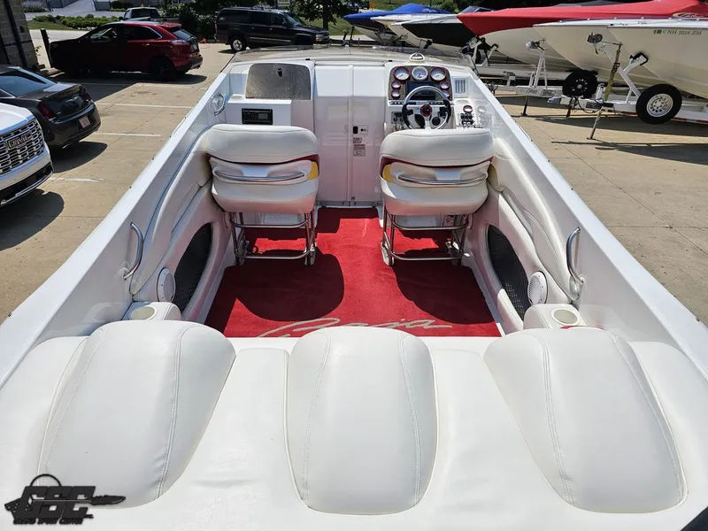 Slide: The Image of 2005 Baja 33 Outlaw boat interior with white seats and red carpet. - 46