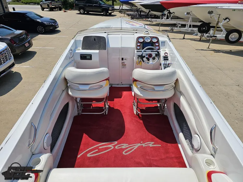 Slide: The Image of 2005 Baja 33 Outlaw boat interior with red carpet and white seating. - 47