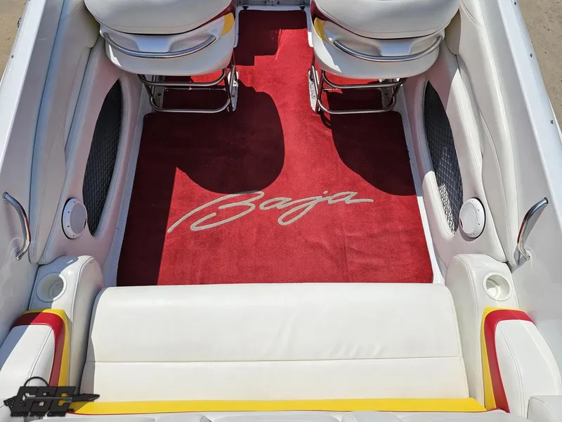 Slide: The Image of 2005 Baja 33 Outlaw boat interior with red carpet and white seating. - 49