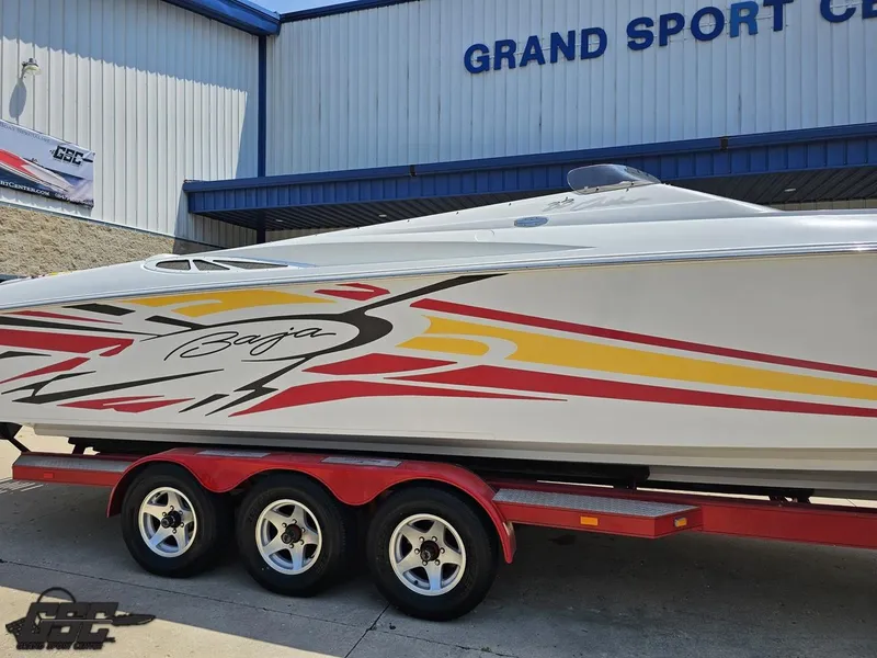 Slide: The Image of 2005 Baja 33 Outlaw boat with vibrant graphics on a red trailer. - 5