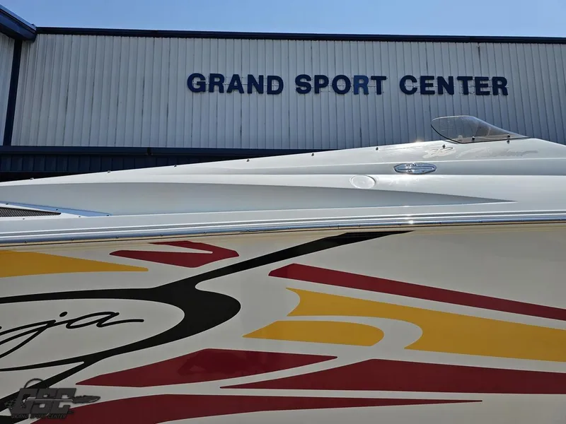 Slide: The Image of 2005 Baja 33 Outlaw boat at Grand Sport Center, featuring vibrant graphics. - 7