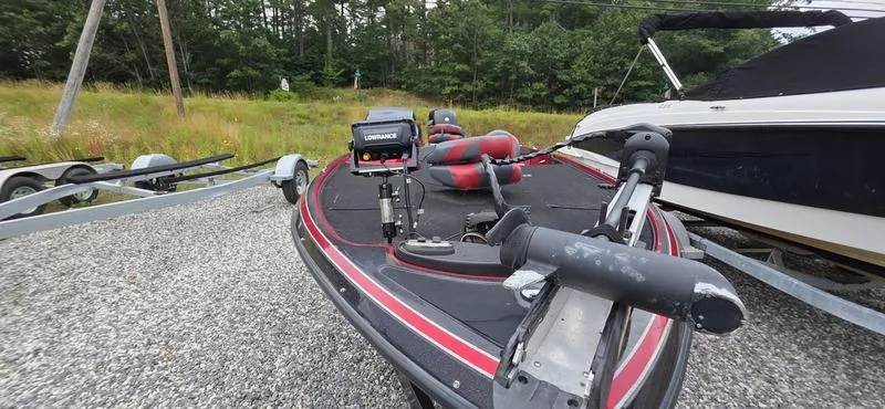 Slide: The Image of 2015 Nitro Z7 boat with Lowrance equipment on a gravel lot, surrounded by trees. - 11