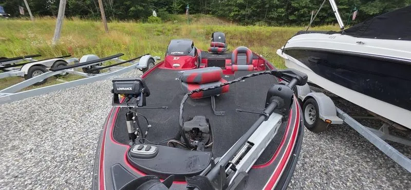 Slide: The Image of 2015 Nitro Z7 boat on trailer, featuring red and black design, parked outdoors. - 6