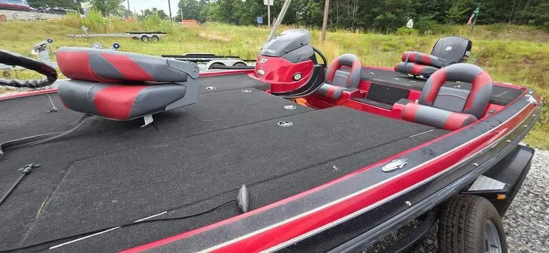 Slide: The Image of 2015 Nitro Z7 boat with red and gray seating, parked on a trailer. - 9