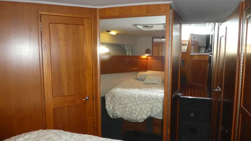 Slide: The Image of 1995 Riviera Convertible interior with wooden cabinetry and cozy bedroom. - 13