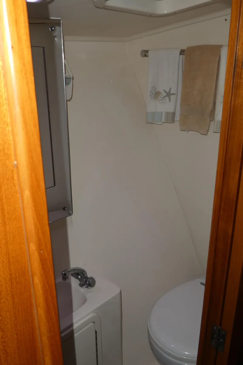 Slide: The Image of 1995 Riviera Convertible bathroom with sink, toilet, and towels on rack. - 14