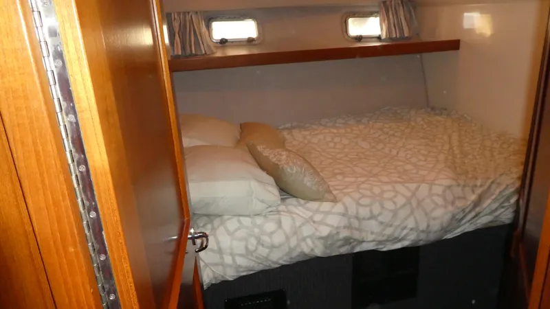 Slide: The Image of Cozy cabin interior of 1995 Riviera Convertible with bed and wooden accents. - 17