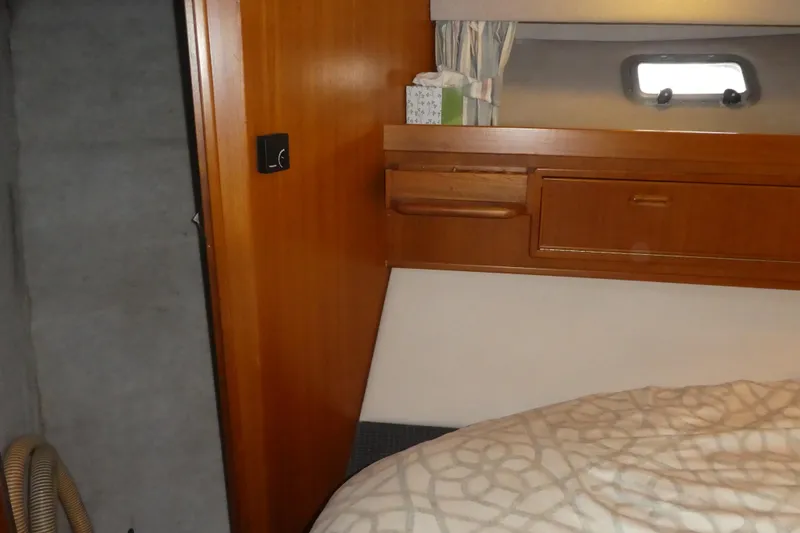 Slide: The Image of 1995 Riviera Convertible interior cabin with wooden cabinetry and bed. - 18