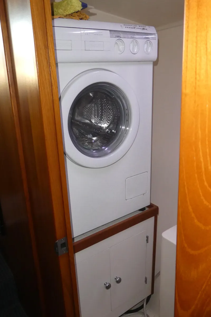 Slide: The Image of Washing machine in a compact wooden cabinet on a 1995 Riviera Convertible. - 19