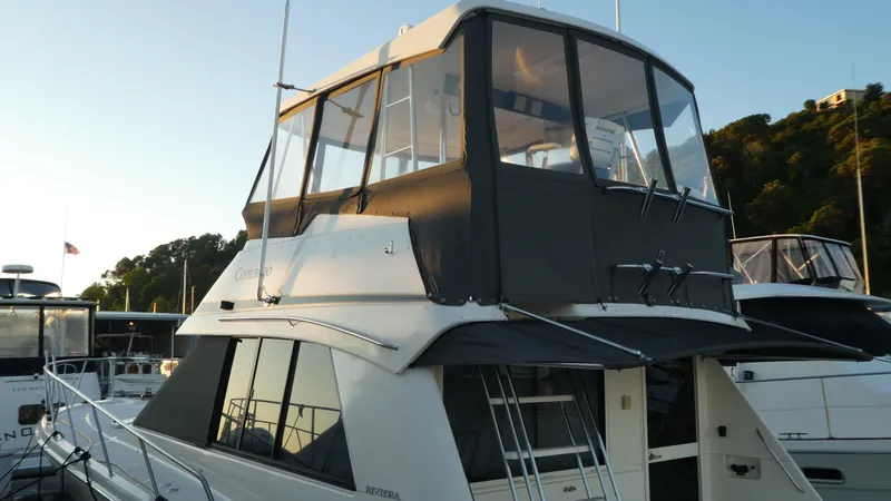 Slide: The Image of 1995 Riviera Convertible yacht docked at marina during sunset. - 2