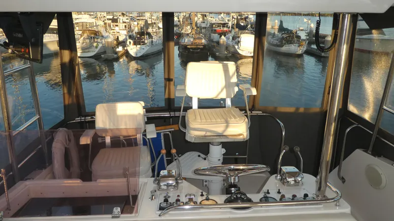 Slide: The Image of Interior of a 1995 Riviera Convertible boat with marina view. - 23