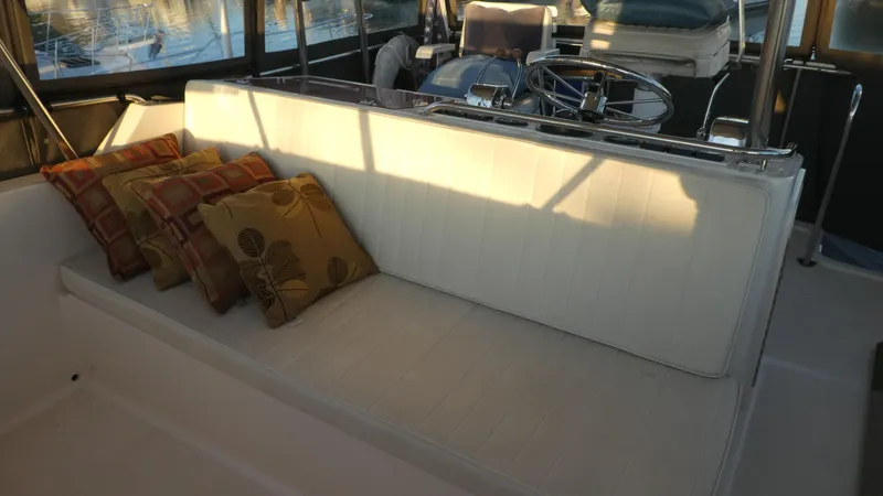 Slide: The Image of 1995 Riviera Convertible boat interior with cushioned seating and decorative pillows. - 24