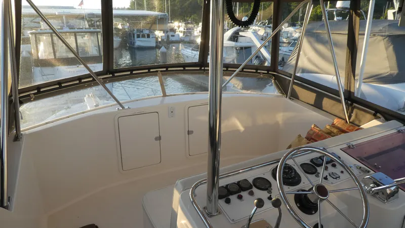 Slide: The Image of 1995 Riviera Convertible boat interior with steering wheel, docked at marina. - 26