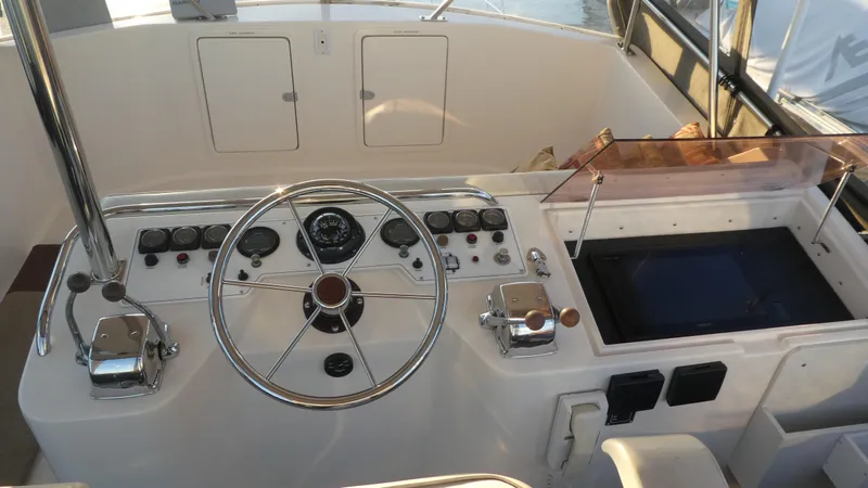 Slide: The Image of 1995 Riviera Convertible boat helm with steering wheel, gauges, and controls. - 27
