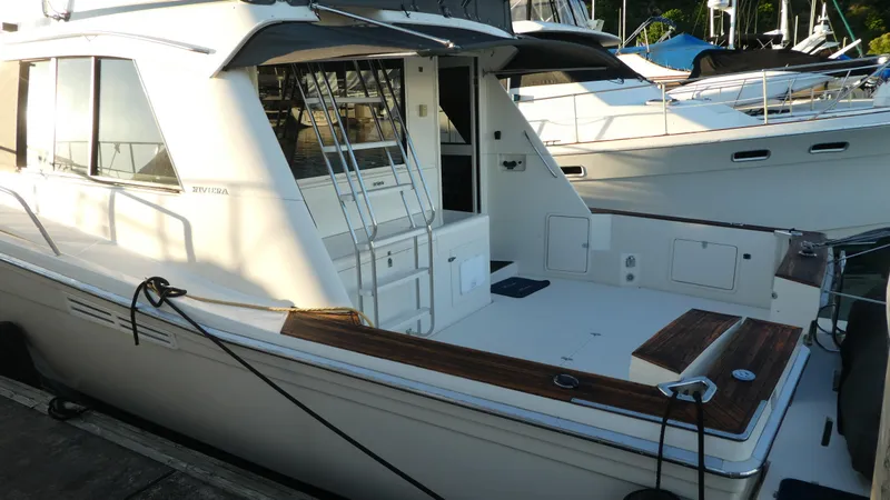 Slide: The Image of 1995 Riviera Convertible yacht docked, featuring spacious deck and sleek design. - 3