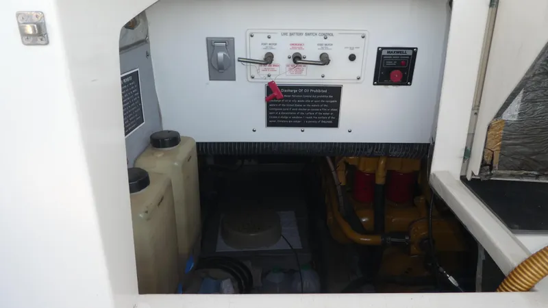 Slide: The Image of Engine compartment of a 1995 Riviera Convertible with battery switch controls and oil containers. - 30