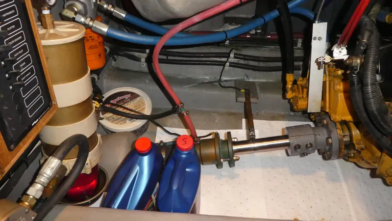 Slide: The Image of Engine room of a 1995 Riviera Convertible with oil containers and mechanical components. - 36