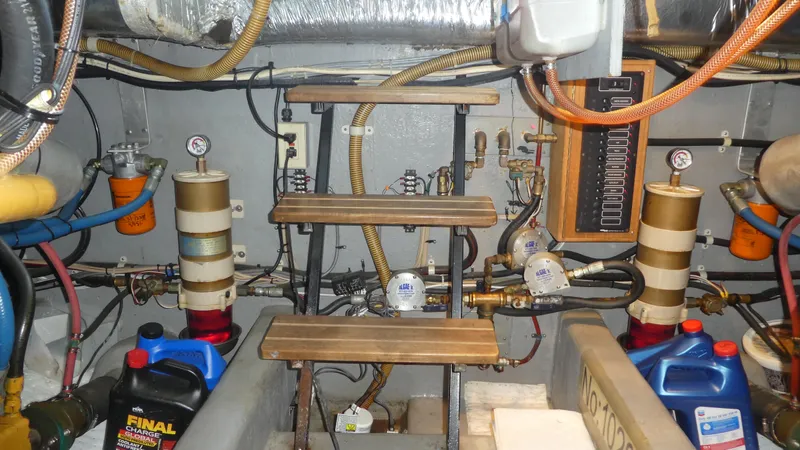 Slide: The Image of Engine room of a 1995 Riviera Convertible with gauges, pipes, and maintenance supplies. - 38