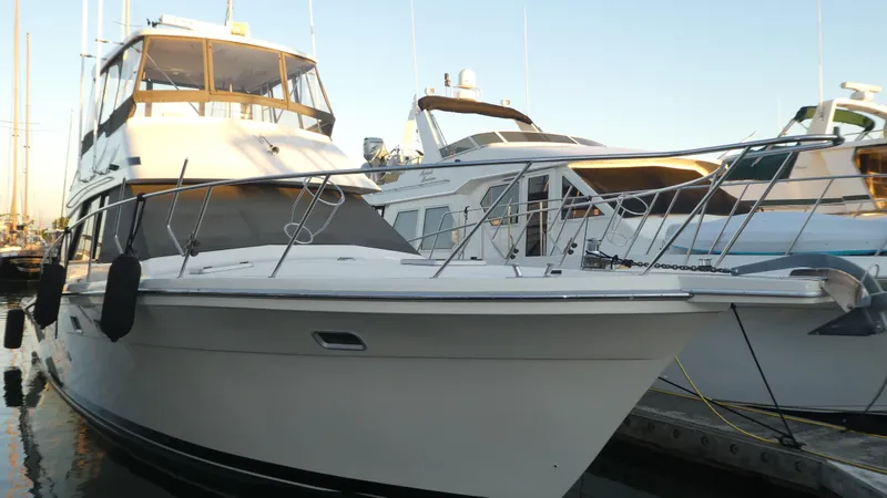 Slide: The Image of 1995 Riviera Convertible yacht docked at marina, showcasing sleek design and spacious deck. - 42