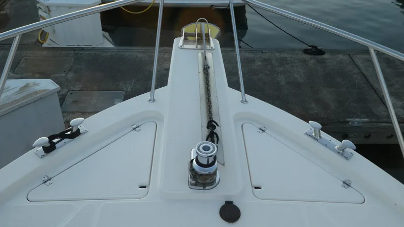 Slide: The Image of 1995 Riviera Convertible boat deck with anchor chain and railing at dock. - 43